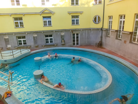 Budapest, Hungary - January 07, 2016: Tourists enjoy at the Lukacs Bath, at historic outdoor thermal bath heated naturally by hot springs, in Budapest, Hungary.のeditorial素材
