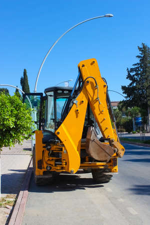 Mini bulldozer or excavation or loader on road. Construction, industry concept.