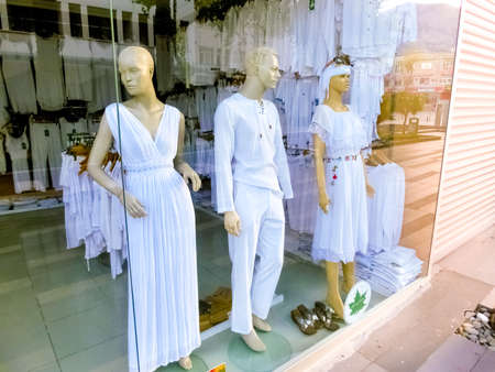Antalya, Turkey - May 11, 2021: The white cotton clothes - dress, blouses, pants at shop or store at Antalya, Turkey on May 11, 2021のeditorial素材