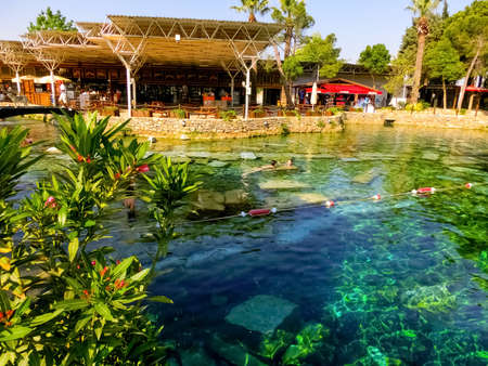 Pamukkale, Turkey- May 11, 2021: People swiming in the Cleopatra pool.のeditorial素材