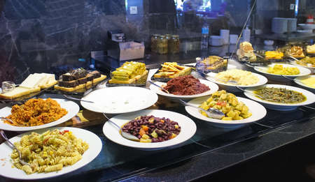 Food on the shelves in the self-service buffet with all inclusive in Turkey at abstract hotel or...