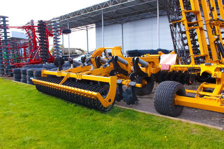 Large disc plow, towing for tractors to plow fields, against the sky