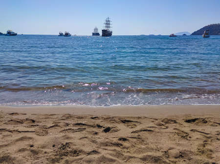Bay in mediterranean sea with old yacht at stone beach at the site of the ancient Lycian city of...