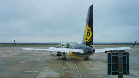 Dortmund, Germany - January 04, 2022: Black and yellow airplane with logo of the german football...