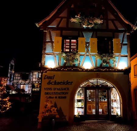 Eguisheim, Alsace, France - December 30, 2021: Night scene in Eguisheim, a traditional village in the Alsace wine region of France, featuring a traditional house, now a wine degustation venueのeditorial素材