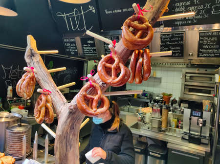 Strasbourg, Alsace, France - December 30, 2021: freshly baked easy grab and go lunch , like pretzel and sausage sandwich vendors street food stall seller in Strasbourg , Alsace , Franceのeditorial素材