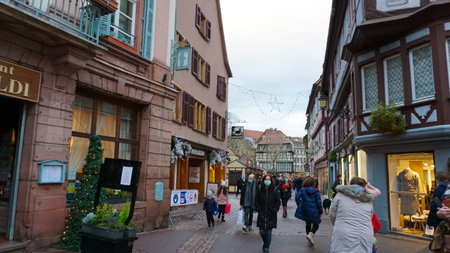 Colmar, France - December 30, 2021: People going at street with Christmas decorations at Colmar, in Alsace region, France.のeditorial素材