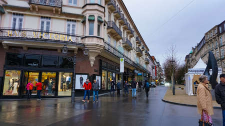 Baden-Baden, Germany - December 29, 2021: People going near historic buildings at the famous old...