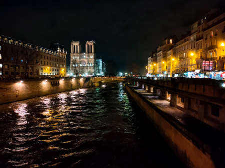 Boat cruising on Seine river at night at Paris.のeditorial素材