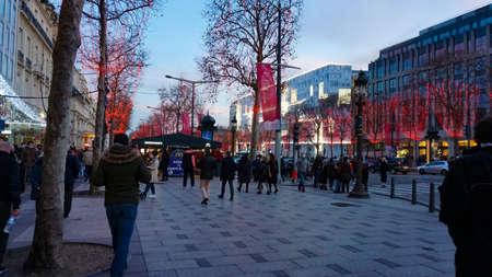 Paris, France - January 01, 2022: People going at Elysian Fields, Champs-Elesees in Paris. Paris -...