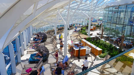 Miami, USA - April 29, 2022: People having fun at pools, bars, entertainment and innovative activities at Symphony of the seas is the biggest cruise ship at Miami, USA on April 29, 2022のeditorial素材