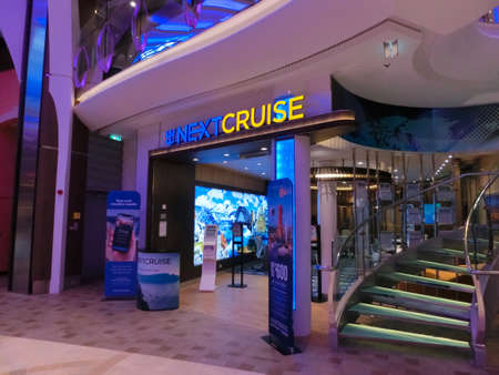 Miami, USA - April 29, 2022: The interior of Promenade at cruise liner Symphony of the Seas by Royal Caribbean. The interior of the shipのeditorial素材