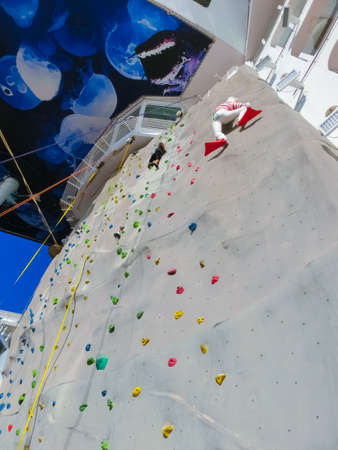 Miami, USA - April 29, 2022: The interior of BoardWalk at cruise liner Symphony of the Seas by Royal Caribbean. The interior of the shipのeditorial素材