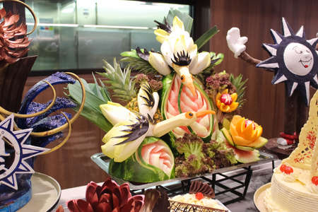 Miami, USA - April 29, 2022: Carving fruits and vegetables at buffet line on board new cruise ship or new flagship of MSC Seashore, the largest cruise ship built in Italy.のeditorial素材