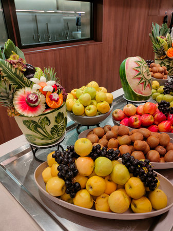 Miami, USA - April 29, 2022: Carving fruits and vegetables at buffet line on board new cruise ship or new flagship of MSC Seashore, the largest cruise ship built in Italy.のeditorial素材