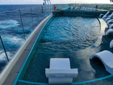 Miami, USA - May 4, 2022: The quiet adult swimming pool area at new cruise ship or new flagship of MSC Seashore, the largest cruise ship built in Italy.のeditorial素材