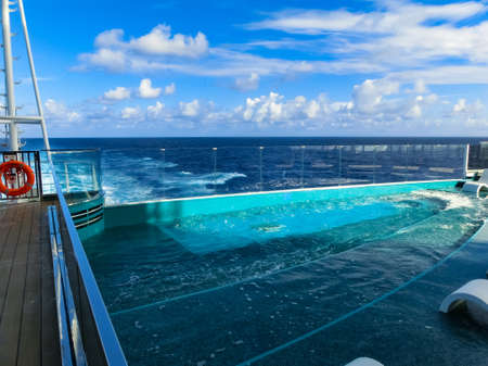 Miami, USA - May 4, 2022: The quiet adult swimming pool area at new cruise ship or new flagship of MSC Seashore, the largest cruise ship built in Italy.のeditorial素材
