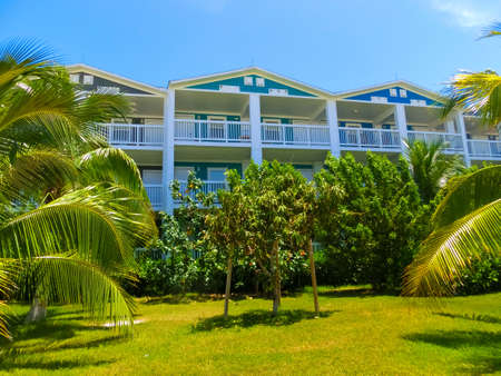Beach on Ocean Cay Bahamas Island with colorful houses and tropic background