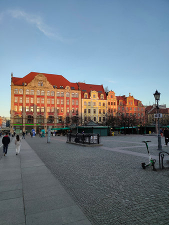 Wroclaw, Poland - April 17, 2022: The people going near old town hall building with a clock in the...