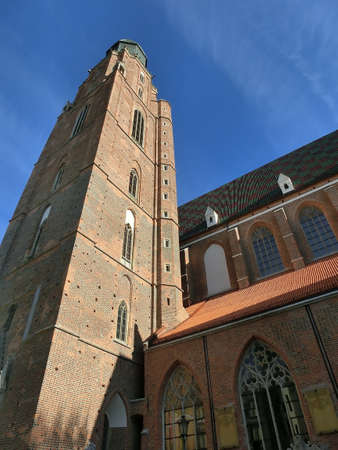 The St Elizabeth Church is hidden behind the houses of old Odrzanska street located next to the Market Square in Wroclaw.の写真素材