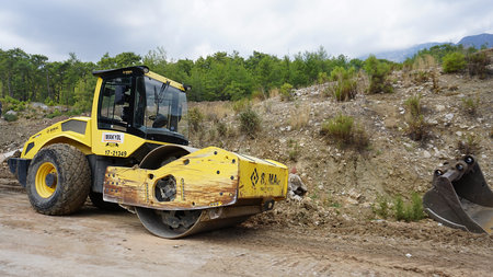 Bucharest, Romania - September 12, 2022: Yellow and black BOMAG road rollers standing in line road at Bucharest, Romania on September 12, 2022のeditorial素材