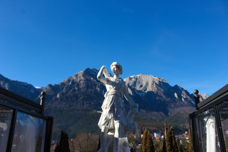 Busteni, Romania - December 30, 2022: Classic white marble statuette Diana head isolated on blue sky background. Scilpture of huntressのeditorial素材