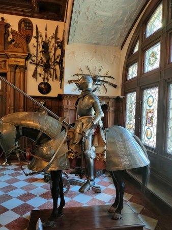 Sinaia, Romania - December 31, 2022: The interior of the Peles castle in Sinaia, in Romania - knightly armor and weapons.のeditorial素材