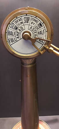 Retro old ship wheel with stand isolated on dark backgroundの写真素材