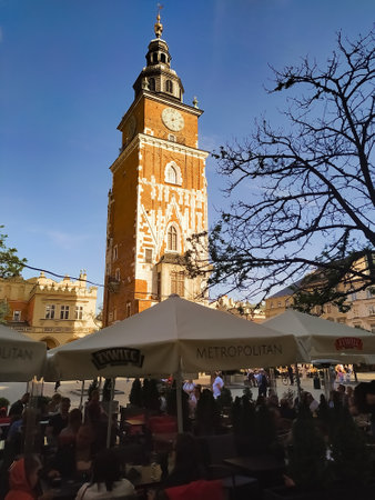 Krakow, Poland - May 22, 2023: People resting near typical old building facade from Krakow old townのeditorial素材