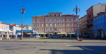 Trieste, Italy - October 1, 2023: The people going at streets of Trieste with the facades of old and colorful Mediterranean houses. Trieste, Italyのeditorial素材