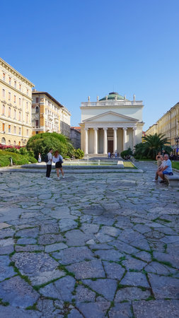 Trieste, Italy - October 1, 2023: The people going at streets of Trieste with the facades of old and colorful Mediterranean houses. Trieste, Italyのeditorial素材