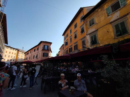 Pisa, Italy - October 4, 2023: People at one of the many picturesque streets in Pisa at Tuscany