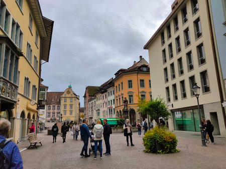 Schaffhausen, Switzerland - October 21, 2023: People going at the old town of Swiss City of Schaffhausen on a foggy day at Schaffhausen, Switzerland on October 21, 2023のeditorial素材