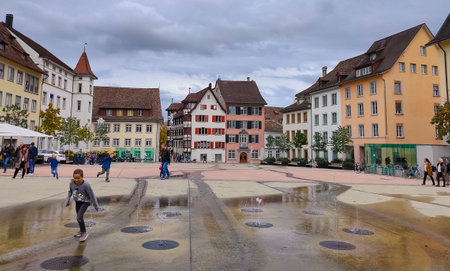 Schaffhausen, Switzerland - October 21, 2023: People going at the old town of Swiss City of Schaffhausen on a foggy day at Schaffhausen, Switzerland on October 21, 2023のeditorial素材