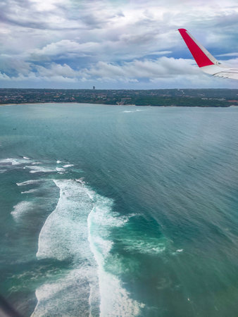 View of a landing airplane out the window at day