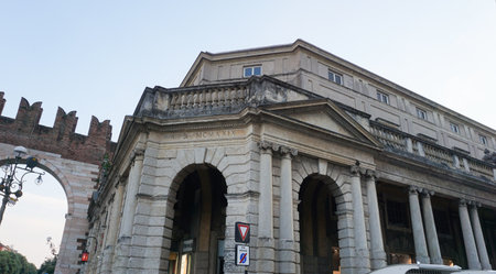 Verona, Italy Latin inscription -For the beauty and benefit of the citizens- at public expense on the portal of Piazza Bra, built in 1929 during the Fascist Era. Neoclassical facade with columnsの写真素材