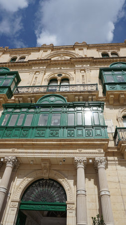 View of old building with windows, balconies in city. Republic of Malta, the picturesque city Valetta, Malta.の写真素材