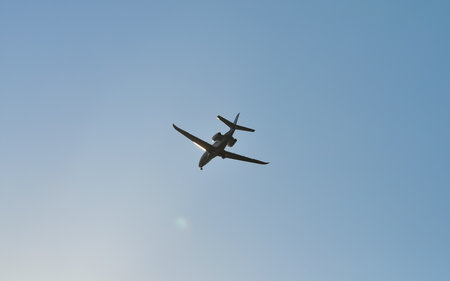 small plane flying low in the skyの写真素材