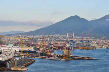 Seaport with cargo ships, cranes, and industrial buildings at Naples, Italyの写真素材