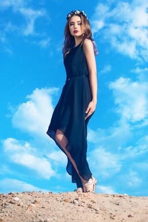 The girl in black dress stands on the mountainの写真素材