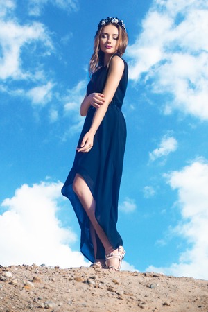 The girl in black dress stands on the mountainの写真素材
