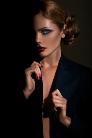 Portrait of beautiful brunette woman in black dress. Fashion photoの写真素材