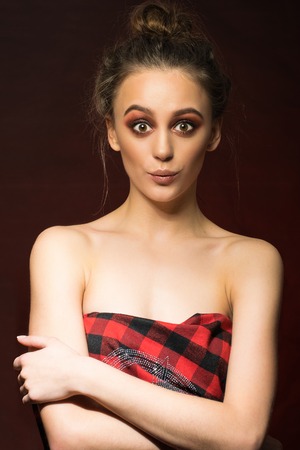 Wonderful woman portrait. Fashionable and stilish make-up. Red background.の写真素材