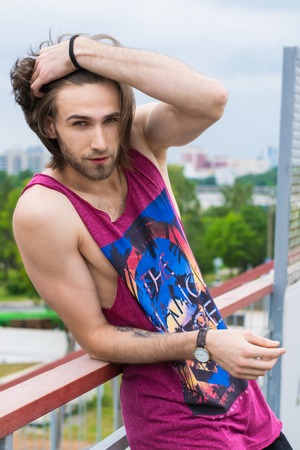 Portrait of a happy smiling man in a city parkの写真素材