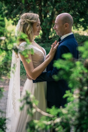 Bride and groom in a city park.の写真素材