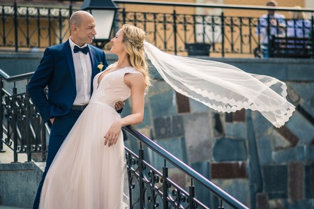 Bride and groom in a park. ouple newlyweds bride and groom at a wedding in nature green forest are kissing photo portrait. Wedding Coupleの写真素材