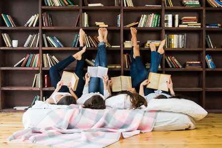 Students doing homework together studio portraitの写真素材