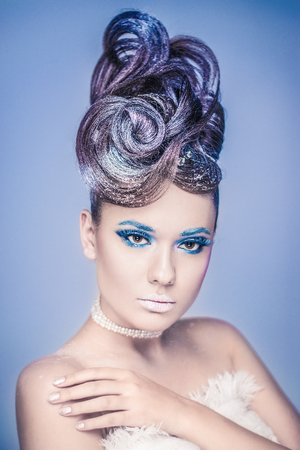 Snow Queen.Fantasy girl portrait. Winter fairy portrait.Young woman with creative silver artistic make-up.の写真素材
