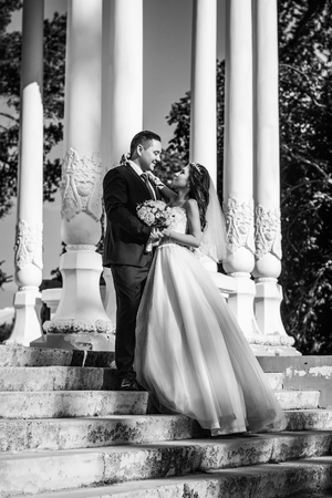 Lovely wedding couple kissing in the cityの写真素材