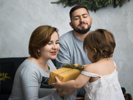 Little girl and his parents kissing. Pregnant woman. So happy familyの写真素材